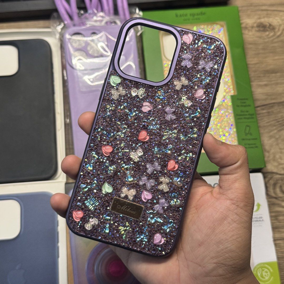 iPhone 15 Pro Max Case FineWoven kate spade PopSockets Mobius (Category: Cases & Sleeves) located in Quezon City. Submitted by consoleciety (Listing ID 1461892659, Image 2). Description: take all 5 cases for ₱1,300 bought for: kate spade new york (₱2,690) PopSockets (₱3,499) Apple FineWoven MagSafe (₱3,990) in poor condition na to Purple case w/ long strap (₱~700) Mobius Purple Bedazzled (₱~600) total: ₱11,479 😅 since i am selling everything for