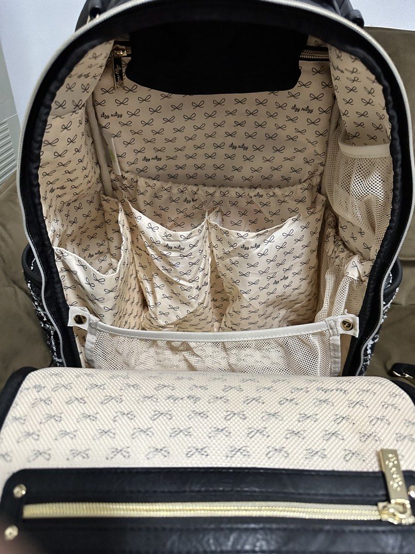 Itzy Ritzy Boss Plus Backpack - Kelly (Category: Backpacks) located in Cainta. Submitted by iamalb (Listing ID 1461892840, Image 2). Description: - Chic black tweed diaper backpack from Itzy Ritzy. - Elegant gold hardware and black faux leather trim. - Multiple interior pockets for superior organization. - Convenient front zip pocket, back pocket for laptop, and insulated side pockets. - Comes with a stylish tassel charm, changing pad, and stroll