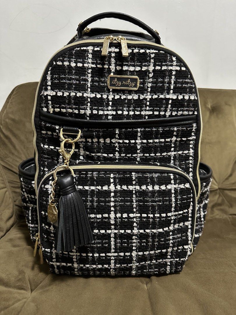 Itzy Ritzy Boss Plus Backpack - Kelly (Category: Backpacks) located in Cainta. Submitted by iamalb (Listing ID 1461892840, Image 1). Description: - Chic black tweed diaper backpack from Itzy Ritzy. - Elegant gold hardware and black faux leather trim. - Multiple interior pockets for superior organization. - Convenient front zip pocket, back pocket for laptop, and insulated side pockets. - Comes with a stylish tassel charm, changing pad, and stroll