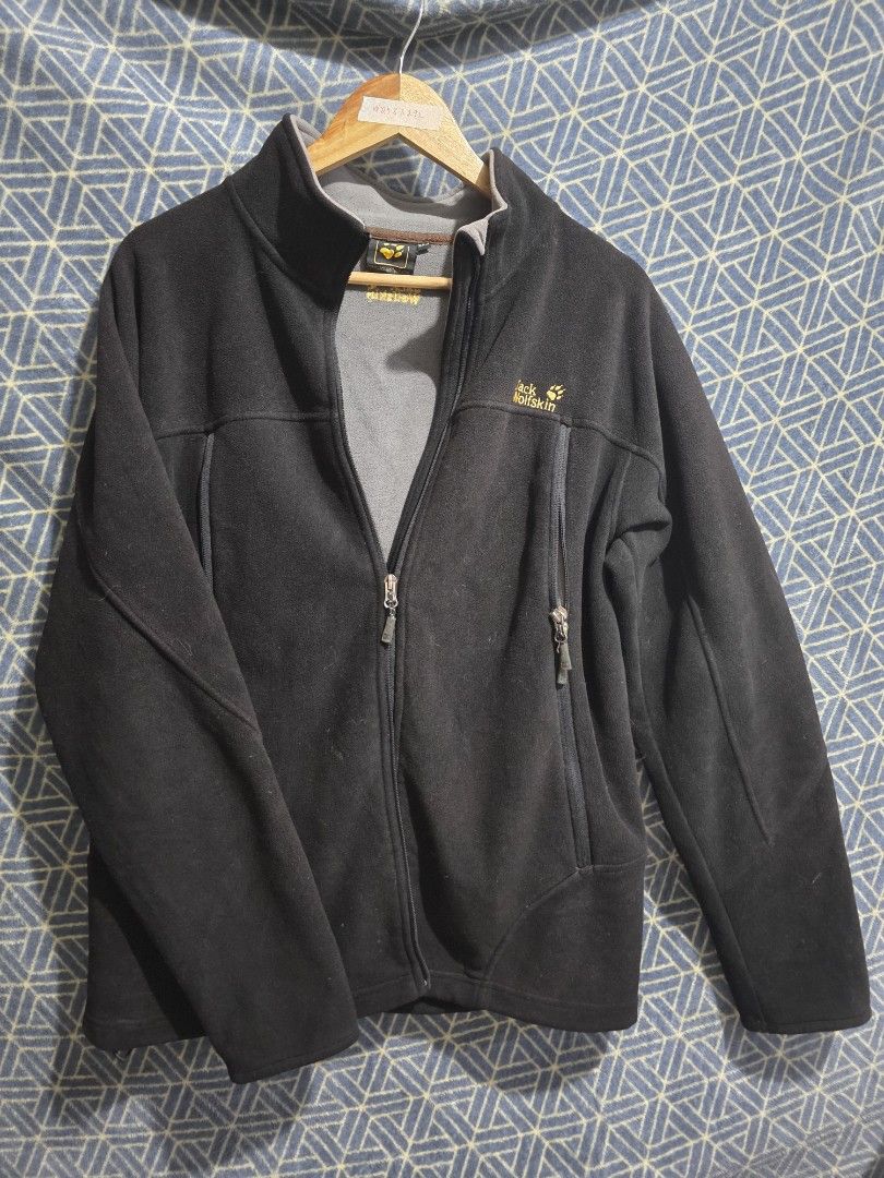 Jack Wolfskin Black Fleece Jacket for Winter (Category: Coats, Jackets and Outerwear) located in Quezon City. Submitted by kick_mnl (Listing ID 1461867377, Image 1). Description: - Brand: Jack Wolfskin - Color: Black - Style: Full zip fleece jacket - Features: 2 zip pockets, contrasting grey inside collar - Material: Soft fleece, great for layering - Use: Suitable for outdoor activities or casual wear ISSUE: zipper cannot be closed. easy replacem