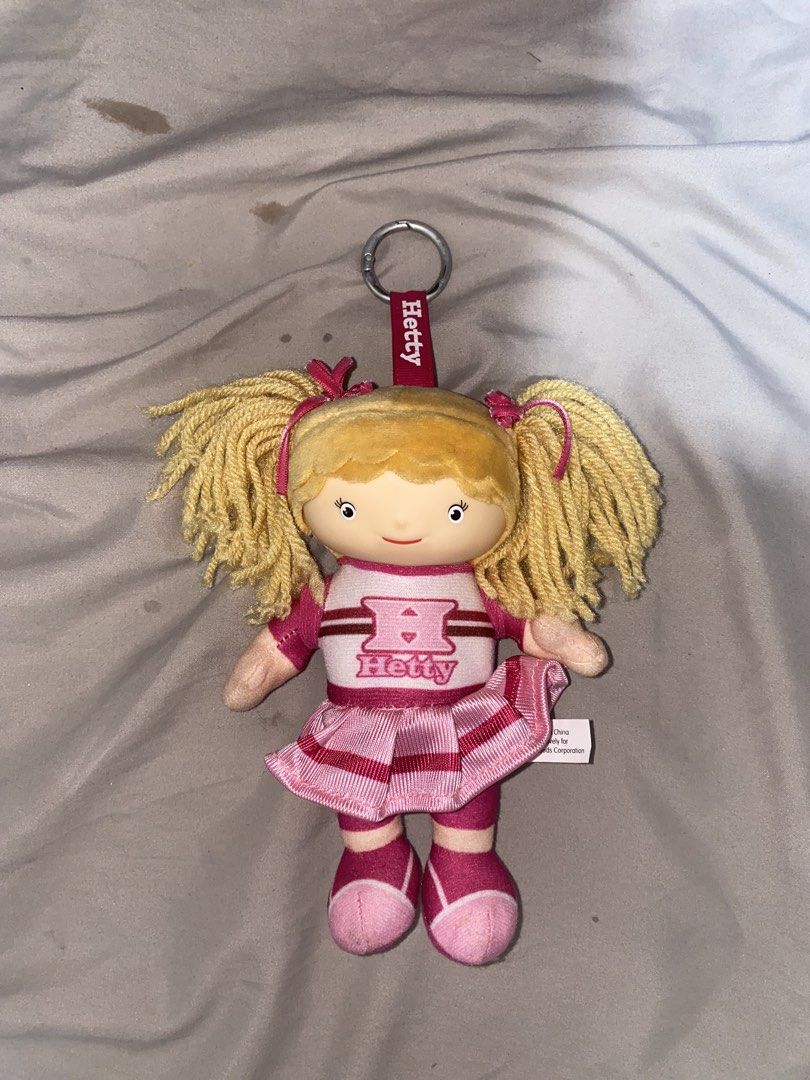 Jollibee Hetty Spaghetti Doll Keychain Plush Toy (Category: Plushies & Soft Toys) located in San Mateo. Submitted by fishermanbeanie (Listing ID 1461844556, Image 1). Description: - Adorable Hetty doll keychain - Features blonde pigtails - Wears a pink and white cheerleader outfit with an 'H' - Comes with an attached keyring - Ideal accessory for bags, backpacks, or as a gift for fans.
