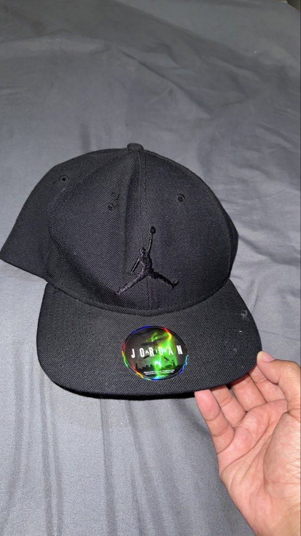 Jordan Snapback Cap Black Jumpman Logo (Category: Caps & Hats) located in Manila. Submitted by nobleangel (Listing ID 1461829364, Image 1). Description: - Classic black Jordan snapback cap - Features iconic embroidered Jumpman logo on the front - Adjustable strap at the back for a customized fit - Original sticker still on the brim - Ideal for casual, everyday style.