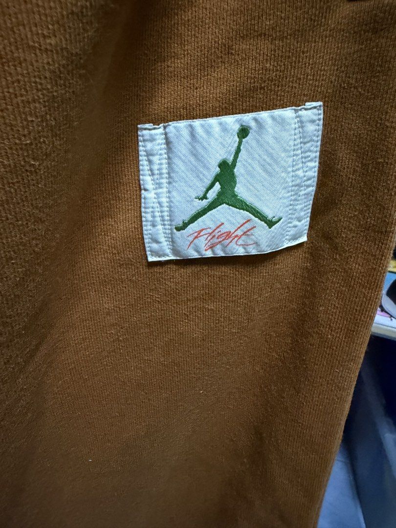 Jordan Sweatpants Brown Fruit Patch (Category: Joggers) located in San Jose del Monte. Submitted by thriftream (Listing ID 1461897076, Image 3). Description: - Brown Jordan sweatpants - Elastic waistband with drawstring - Two side pockets - Small embroidered fruit patch on left leg - Jordan Flight patch on right leg - Authentic, No flaws.