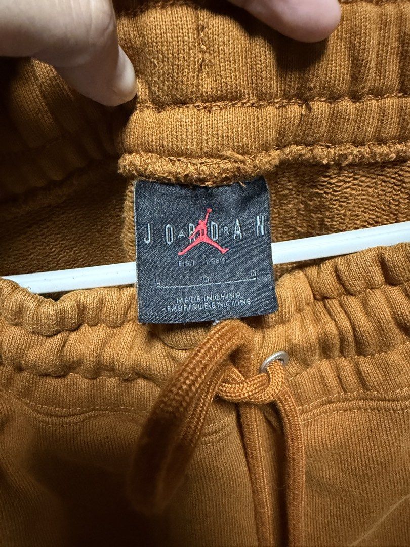 Jordan Sweatpants Brown Fruit Patch (Category: Joggers) located in San Jose del Monte. Submitted by thriftream (Listing ID 1461897076, Image 2). Description: - Brown Jordan sweatpants - Elastic waistband with drawstring - Two side pockets - Small embroidered fruit patch on left leg - Jordan Flight patch on right leg - Authentic, No flaws.