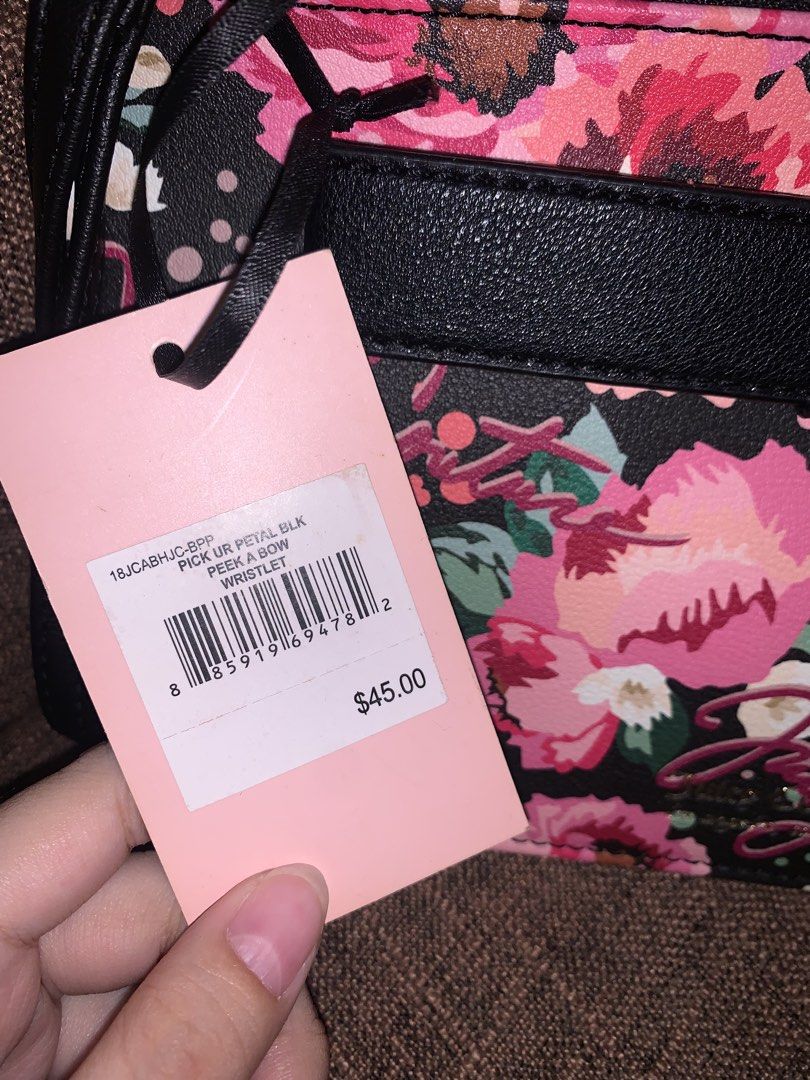 Juicy Couture Wallet Purse (Category: Purses & Pouches) located in Manila. Submitted by jei_sol (Listing ID 1461910725, Image 3). Description: ORIGINAL JUICY COUTURE FROM U.S.A. - Cute Juicy Couture wristlet - Black background with vibrant floral print - Black bow detail with gold heart accent - Interior features multiple card slots and a zip pocket - Comes with original tags - Perfect for carrying your essentials.