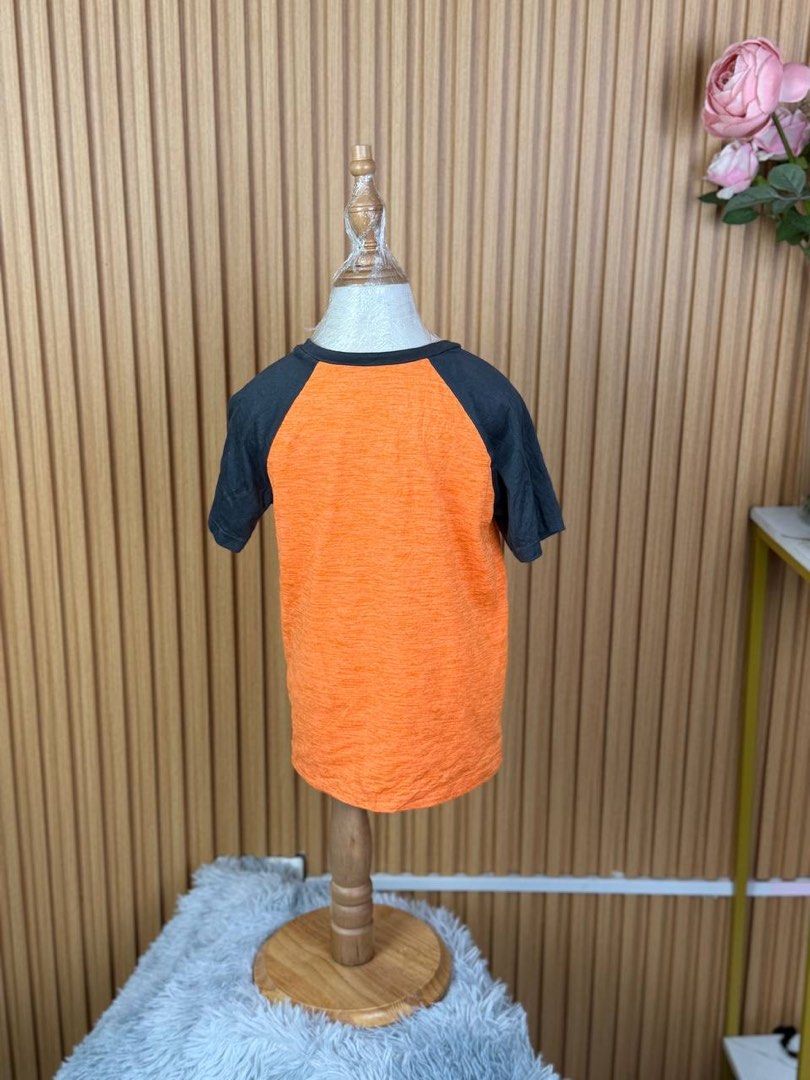 Jumping Beans Active Baseball T-shirt Size 5 Orange (Category: Tshirts & Polo Shirts ) located in Batangas. Submitted by ishaswonders (Listing ID 1461890676, Image 2). Description: - Vibrant orange t-shirt with a cool baseball graphic - Stylish dark grey raglan sleeves - Crafted from a comfortable recycled polyester and spandex blend - Designed for active kids, offering ease of wear - Ideal for everyday play and comfort.