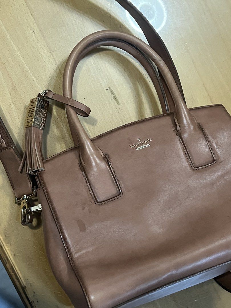 Kate Spade Leather Handbag (Category: Luxury Bags & Wallets) located in San Mateo. Submitted by aishtela (Listing ID 1461993272, Image 2). Description: - Genuine brown leather Kate Spade handbag - Features a stylish tassel charm - Includes a detachable strap for versatile wear - Ample interior space for your essentials - Ideal for everyday use.