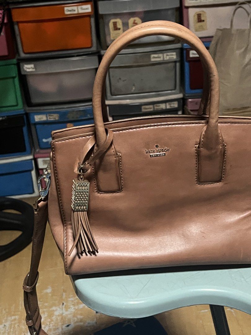 Kate Spade Leather Handbag (Category: Luxury Bags & Wallets) located in San Mateo. Submitted by aishtela (Listing ID 1461993272, Image 1). Description: - Genuine brown leather Kate Spade handbag - Features a stylish tassel charm - Includes a detachable strap for versatile wear - Ample interior space for your essentials - Ideal for everyday use.