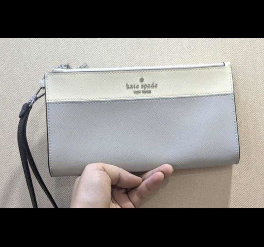 Kate Spade New York Wristlet (Category: Luxury Bags & Wallets) located in Valenzuela. Submitted by boutiquechic (Listing ID 1461942505, Image 1). Description: - Authentic Kate Spade wristlet - Stylish two-tone: cream and light grey - Durable black wrist strap - Secure top zipper closure - Front Kate Spade New York logo detail - Ideal for carrying everyday essentials.