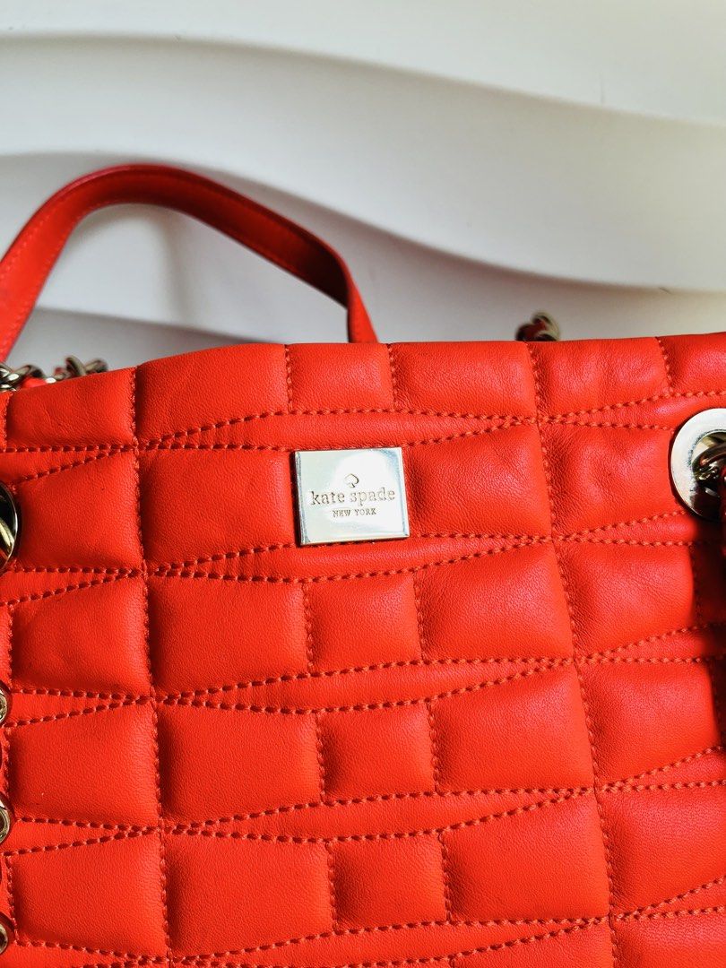Kate Spade Quilted Leather Chain Shoulder Bag (Category: Luxury Bags & Wallets) located in Davao. Submitted by goodthingsph_ (Listing ID 1462034795, Image 3). Description: - Bright orange quilted leather handbag - Brand: Kate Spade - Silver chain detailing on straps - Fun, patterned interior lining - Spacious main compartment - Perfect for everyday or special occasions.