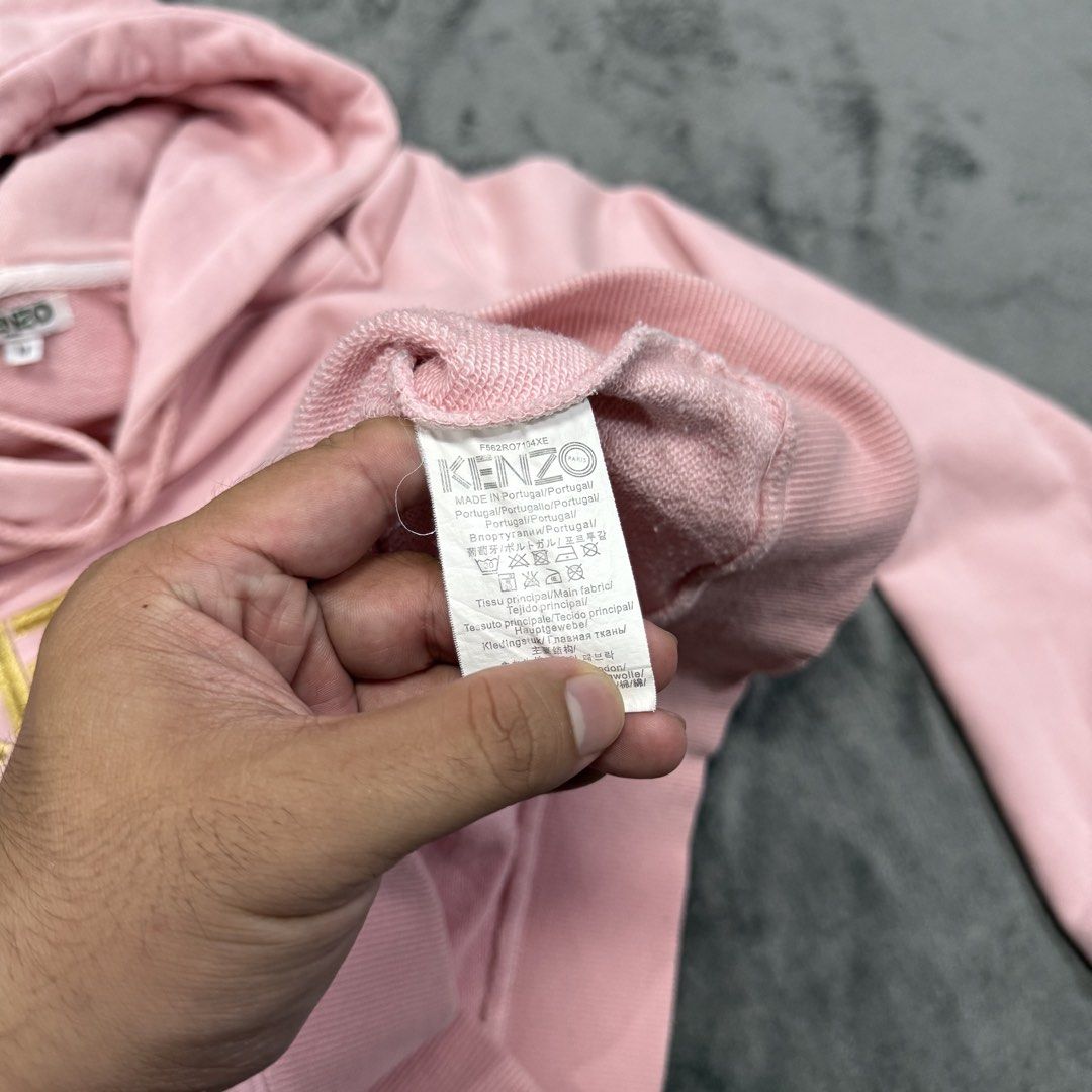 KENZO PULLOVER PINK HOODIE (Category: Coats, Jackets and Outerwear) located in Santa Maria. Submitted by rarefindslt (Listing ID 1461833456, Image 3). Description: KENZO PULLOVER PINK HOODIE (SWIPE LEFT FOR MORE DETAILS..) M on tag in solid pink color condition rate, with adjustable string on hoodie, front pocket, pink cotton hoodie featuring an embroidered yellow "KENZO" logo across the chest, back hit tiger script paris!.