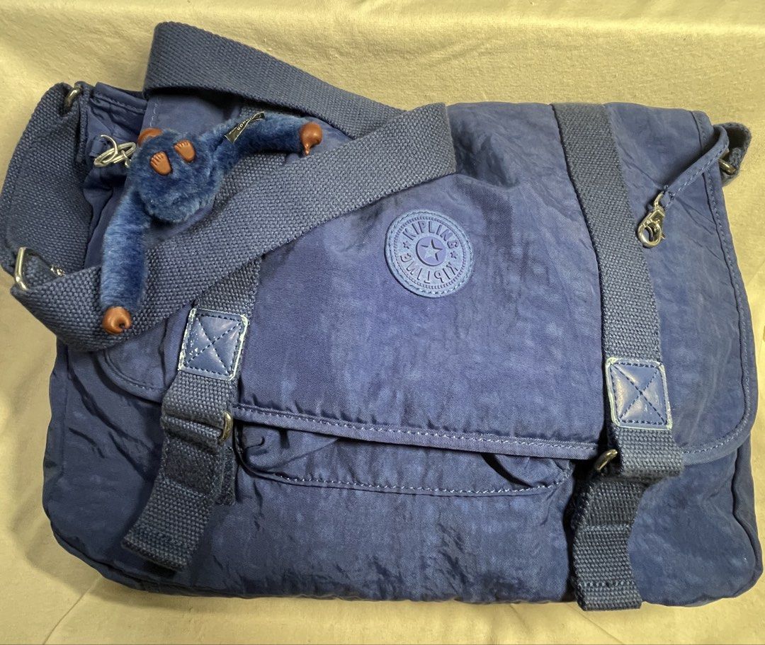Kipling Blue Nylon Messenger Bag with Monkey Charm (Category: Sling Bags) located in Mandaluyong City. Submitted by coolmeybab (Listing ID 1461822643, Image 2). Description: - Durable blue nylon Kipling messenger bag - Secure velcro flap closure - Interior zippered pocket for essentials - Includes signature Kipling monkey charm - Adjustable shoulder strap for comfort - Ideal for everyday use.