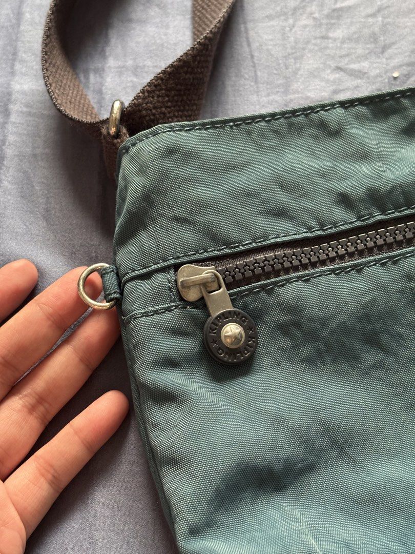 Kipling Teal & Black Nylon Crossbody Bag (Category: Cross-body Bags) located in Bacolod City. Submitted by nczr96 (Listing ID 1461874388, Image 3). Description: - Stylish teal and black Kipling crossbody bag - Durable nylon material - Adjustable strap with metal buckle for a custom fit - Secure main compartment and front zip pocket - Authentic Kipling logo on the front - Ideal for everyday use and travel Bought in Singapore No flaws at all Rfs: d