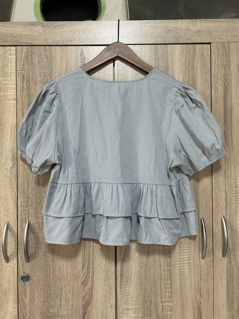 Korean blue top (Category: Blouses) located in Bulacan. Submitted by relove.re (Listing ID 1461923458, Image 2). Description: - Korean blouse top - S to M Size - with raffles peplum bottom - whit tie knot / ribbon and button styled - puff sleeve with garter - Baby Blue color .