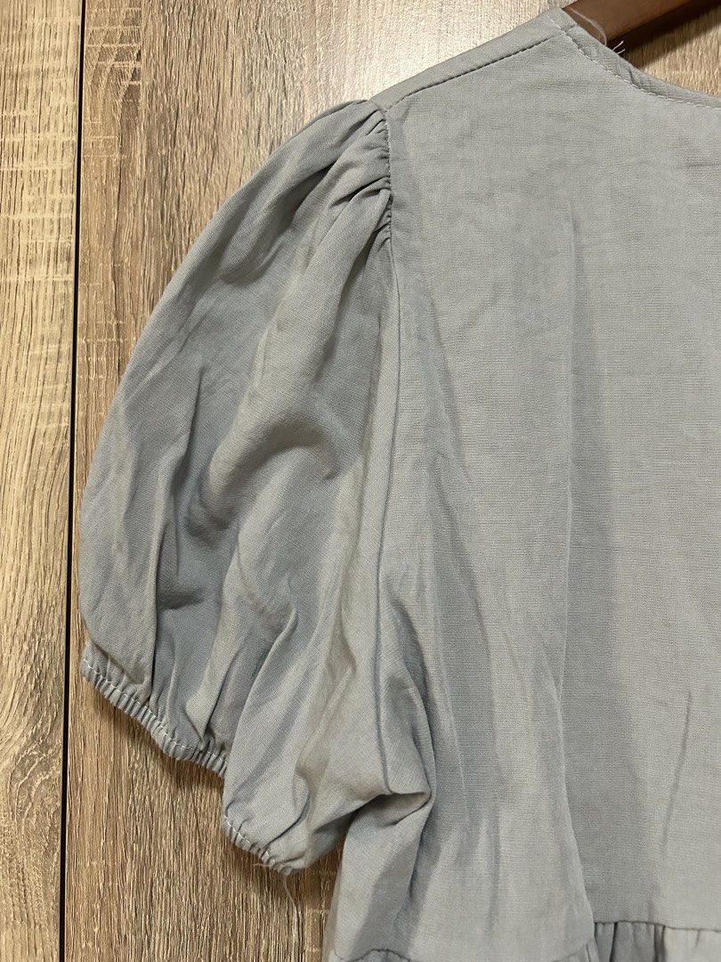 Korean blue top (Category: Blouses) located in Bulacan. Submitted by relove.re (Listing ID 1461923458, Image 3). Description: - Korean blouse top - S to M Size - with raffles peplum bottom - whit tie knot / ribbon and button styled - puff sleeve with garter - Baby Blue color .