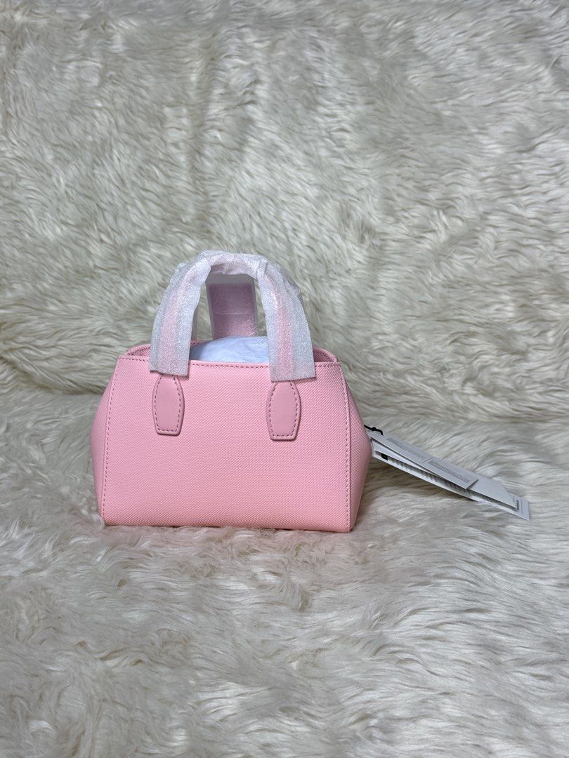 Lacoste Pink Mini Tote Bag (Category: Tote Bags) located in Cebu City. Submitted by hazelcris (Listing ID 1461845834, Image 2). Description: - Cute pink mini tote bag from Lacoste - Signature crocodile logo embossed on the front - Handles still have protective plastic wrap - Brand new with tags attached - Lined interior with a small pocket - Ideal for carrying your daily essentials.