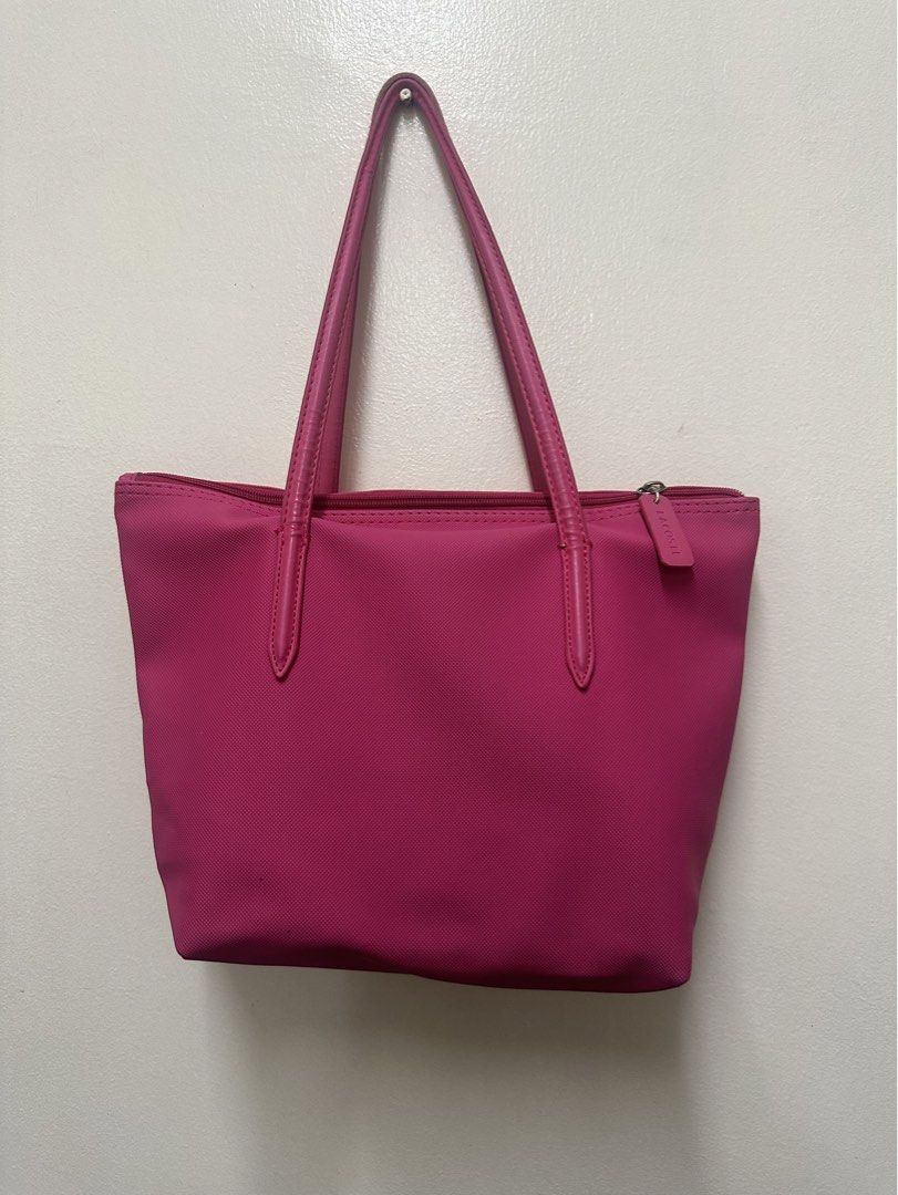 Lacoste Pink Tote Bag (Category: Tote Bags) located in Manila. Submitted by simplysorted27 (Listing ID 1461887228, Image 2). Description: - Pink Lacoste tote bag - Zip closure on top - Durable leather handles - Simple and classic design - Ideal for everyday use - Spacious enough for essentials.