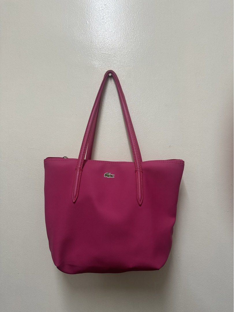 Lacoste Pink Tote Bag (Category: Tote Bags) located in Manila. Submitted by simplysorted27 (Listing ID 1461887228, Image 1). Description: - Pink Lacoste tote bag - Zip closure on top - Durable leather handles - Simple and classic design - Ideal for everyday use - Spacious enough for essentials.
