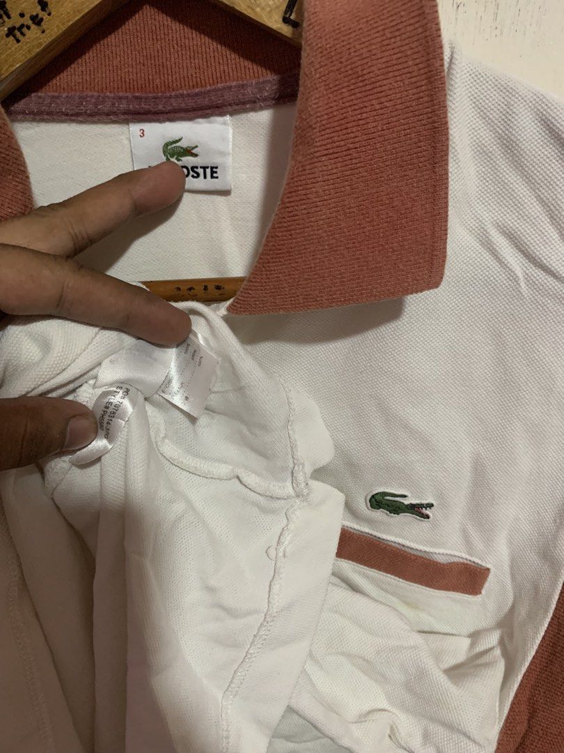 Lacoste Polo Shirt White & Rust Color Block (Category: Tshirts & Polo Shirts ) located in Bauang. Submitted by jkjk32 (Listing ID 1461957997, Image 2). Description: - Classic Lacoste polo shirt - White body with rust colored sleeves and collar - Iconic crocodile logo on chest pocket - Size 3 - Ideal for casual wear.