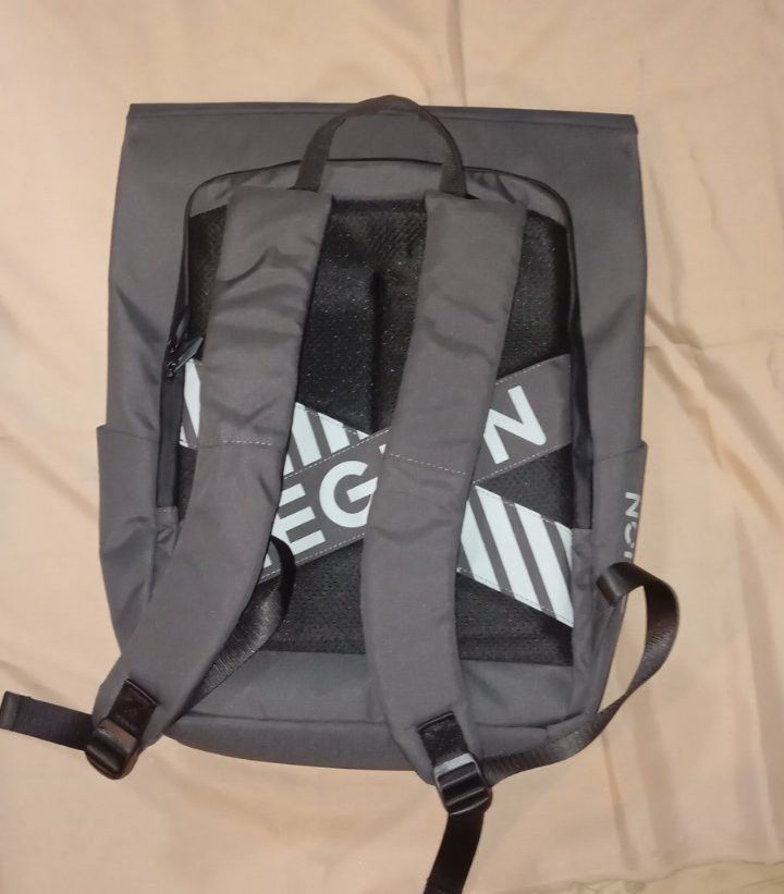 Legion Backpack Original (Category: Backpacks) located in Manila. Submitted by hi.yunichi (Listing ID 1462009410, Image 2). Description: NEED WASH ONLY - Stylish grey backpack with a convenient fold-over top. - Easy-access side pockets for essentials. - Comfortable padded shoulder straps for all-day wear. - Safety first with reflective stripes on front and back straps. - Includes an internal laptop sleeve, ideal for students and professionals. - 
