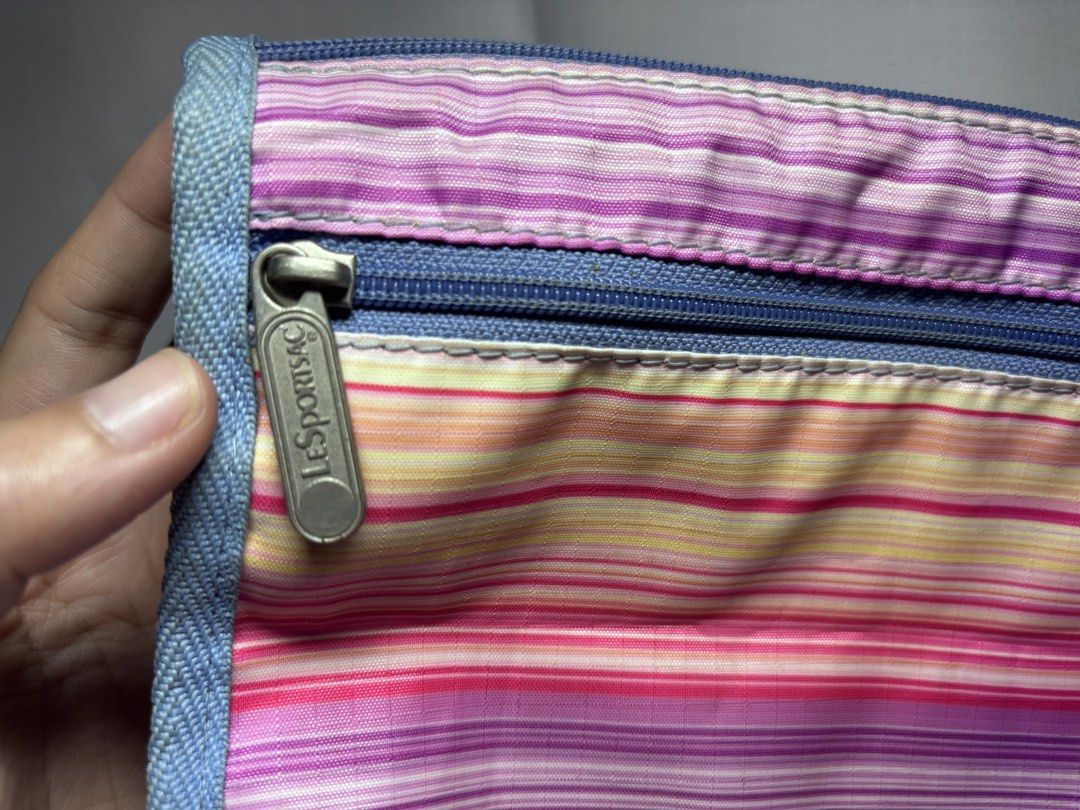 LeSportsac Striped Pouch (Category: Purses & Pouches) located in Sablan. Submitted by 21enygrace.ph (Listing ID 1461940420, Image 2). Description: - Cute LeSportsac pouch - Colorful stripe pattern - Zippered main compartment - Smaller zippered pocket on the front - Light denim material on the sides - Ideal for organizing small items in your bag - Needs wash.