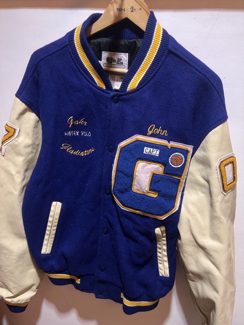Letter man varsity jacket (Category: Coats, Jackets and Outerwear) located in San Juan, La Union. Submitted by jeggystyle (Listing ID 1461961818, Image 2). Description: - Vintage varsity jacket - Blue wool body with cream leather sleeves - 'John' and 'Gladiators Water Polo' embroidery on front - 'CAPT' patch on chest - 'Mayer' embroidery on back - Ribbed collar, cuffs, and hem - Button-up closure.