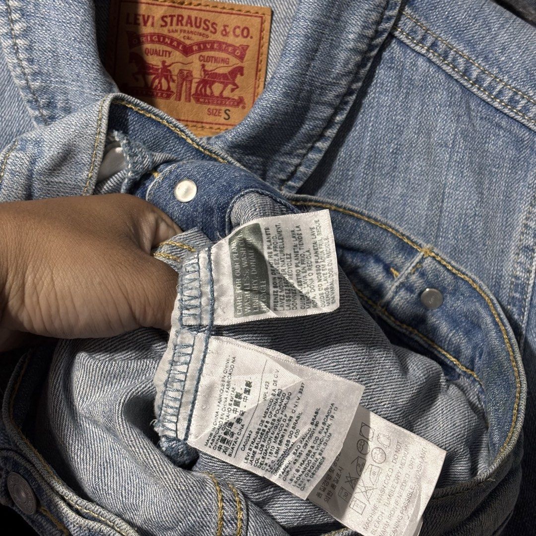 Levi's Denim Jacket - Size S - Very Good Condition (Category: Coats, Jackets and Outerwear) located in Caloocan City. Submitted by bonsatocha43876 (Listing ID 1461984128, Image 2). Description: - Classic Levi's denim jacket - Light blue wash - Button-up front with two chest pockets - Measurements: 18 inches width, 20 inches length - Original tags complete - Perfect wardrobe staple - Price: 750 pesos only.