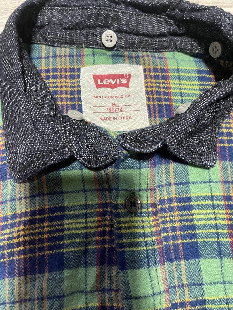 Levi's Patchwork Flannel Denim Shirt Size M (Category: Babies & Kids Fashion) located in Manila. Submitted by rayuki39 (Listing ID 1461913647, Image 2). Description: - Authentic Levi's shirt with a unique patchwork design. - Combines red plaid, green plaid, and classic denim fabric. - Denim collar and sleeves for a stylish look. - Tag size: M (150/72). - Material: 100% Cotton shell fabric. - Origin: Made in China..