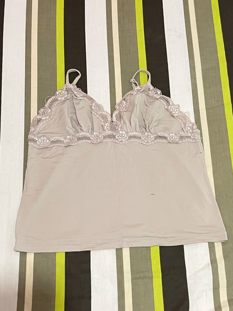Light Green Lace Trim Camisole Top (Category: Sleeveless) located in Santa Rosa. Submitted by rsxyen (Listing ID 1461994755, Image 1). Description: - Light green camisole - Delicate lace trim along neckline - Adjustable straps for a comfortable fit - Soft and smooth fabric - Minor marks on the front (refer to close-up photo) - Versatile for layering or wearing on its own.