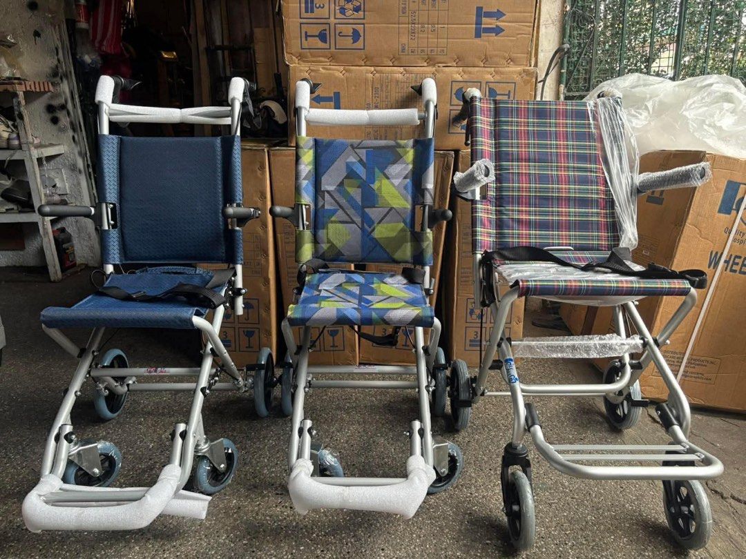 Lightweight Folding Wheelchairs - Available in 3 Styles (Category: Wheelchairs) located in Manila. Submitted by rosel2001 (Listing ID 1461830317, Image 1). Description: - Lightweight wheelchairs, perfect for mobility assistance. - Two chairs feature solid blue seats, one with a geometric pattern. - One chair has a stylish plaid design. - All chairs are foldable for convenient transport and storage. - Ready to find their new homes!.