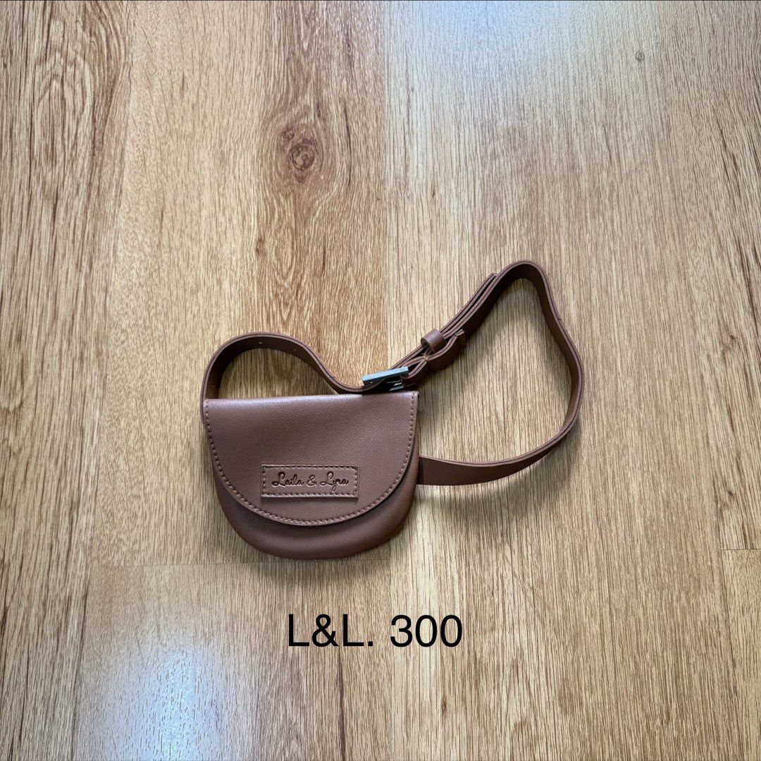 L&L Brown Leather Belt Bag (Category: Babies & Kids Fashion) located in Manila. Submitted by little_dees_shop (Listing ID 1461816417, Image 1). Description: - Brand: L&L - Material: Brown Leather - Design: Small and compact belt bag - Strap: Adjustable with buckle closure - Features: Embossed logo on front flap - Ideal for: Carrying essentials on the go.