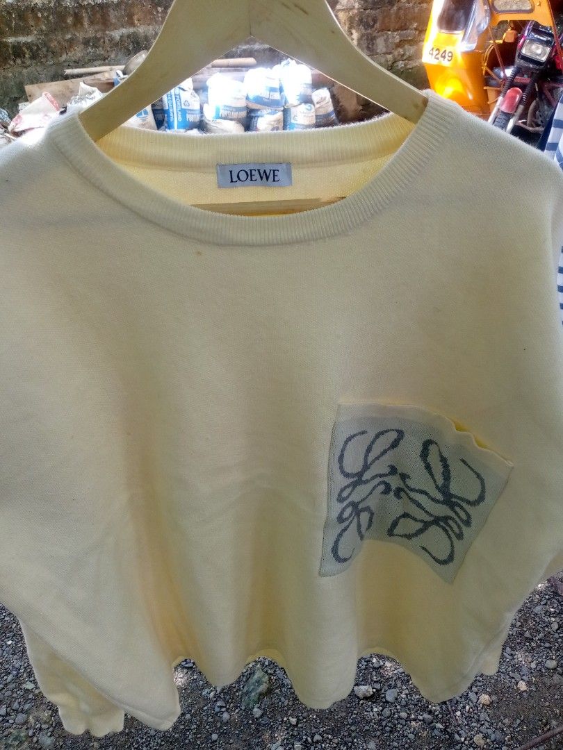 LOEWE Yellow Sweater with Anagram Pocket (Category: Longsleeves) located in Manila. Submitted by adrianloqu02215 (Listing ID 1461813086, Image 3). Description: - Yellow LOEWE sweater - Features iconic Anagram logo on pocket detail - Crew neck, long sleeves - Comfortable knit fabric - Versatile for casual wear - Pairs well with jeans or shorts.