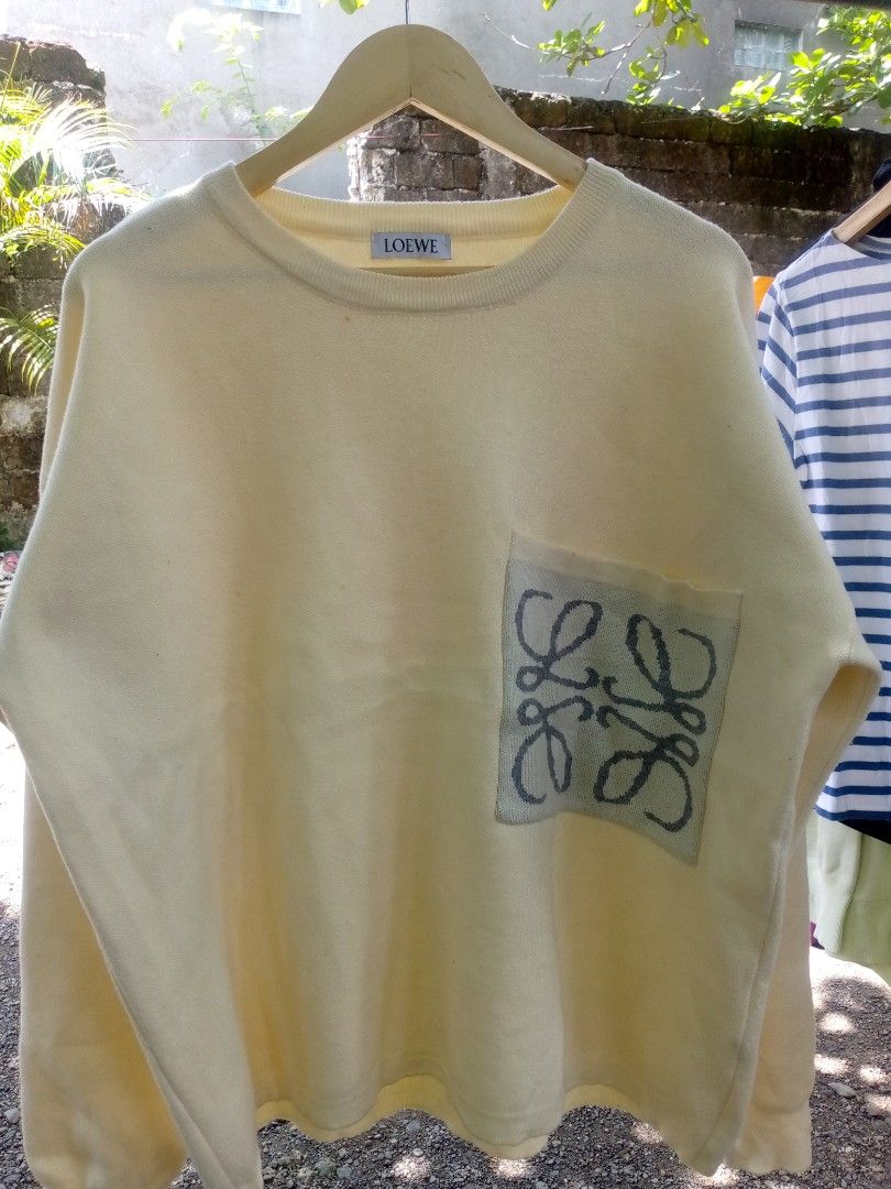 LOEWE Yellow Sweater with Anagram Pocket (Category: Longsleeves) located in Manila. Submitted by adrianloqu02215 (Listing ID 1461813086, Image 2). Description: - Yellow LOEWE sweater - Features iconic Anagram logo on pocket detail - Crew neck, long sleeves - Comfortable knit fabric - Versatile for casual wear - Pairs well with jeans or shorts.