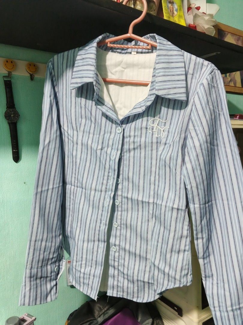 Long sleeve college type shirt (Category: Longsleeves) located in Manila. Submitted by merishaylll (Listing ID 1461948327, Image 2). Description: - Light blue and white striped long-sleeve shirt - Button-up front with a classic collar - Small embroidered detail on the chest - Fitted silhouette for a modern look - Sleeve cuffs for a polished finish - Perfect for both casual and smart outfits.