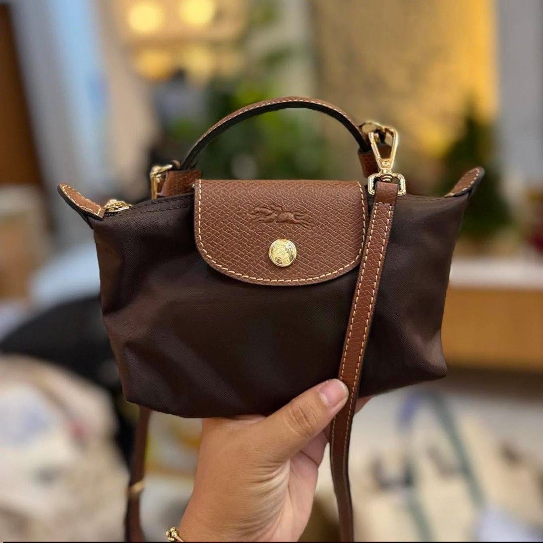 Longchamp Le Pliage Cuir Small Top Handle Bag (Category: Luxury Bags & Wallets) located in Manila. Submitted by thrift_thrill (Listing ID 1461972540, Image 2). Description: - Authentic Longchamp Le Pliage Cuir Bag - Small Size: Ideal for carrying essentials - Versatile: Comes with a top handle and a detachable shoulder strap - Available Colors: Brown, Dark Grey, Black - Material: Genuine leather trim - Style: Very practical and stylish.