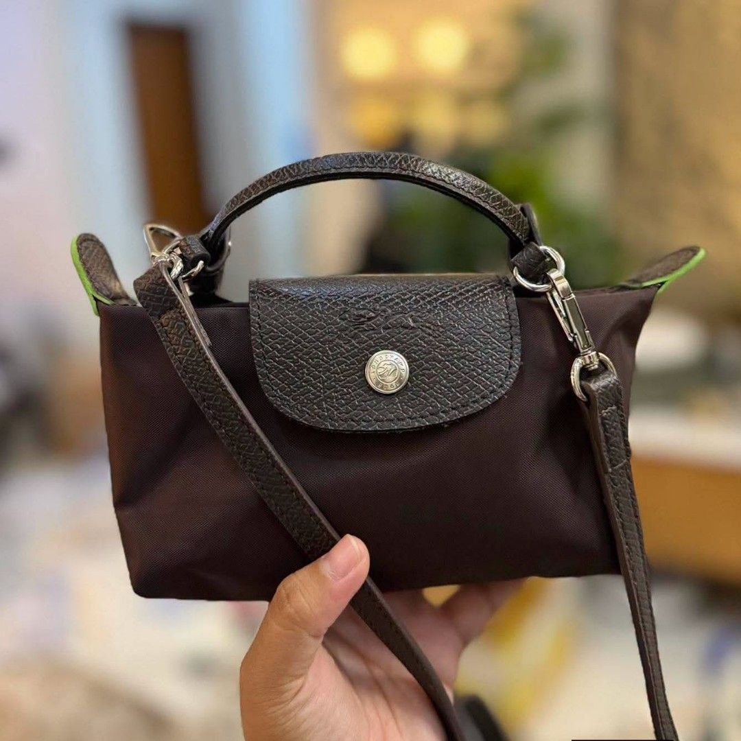 Longchamp Le Pliage Cuir Small Top Handle Bag (Category: Luxury Bags & Wallets) located in Manila. Submitted by thrift_thrill (Listing ID 1461972540, Image 3). Description: - Authentic Longchamp Le Pliage Cuir Bag - Small Size: Ideal for carrying essentials - Versatile: Comes with a top handle and a detachable shoulder strap - Available Colors: Brown, Dark Grey, Black - Material: Genuine leather trim - Style: Very practical and stylish.