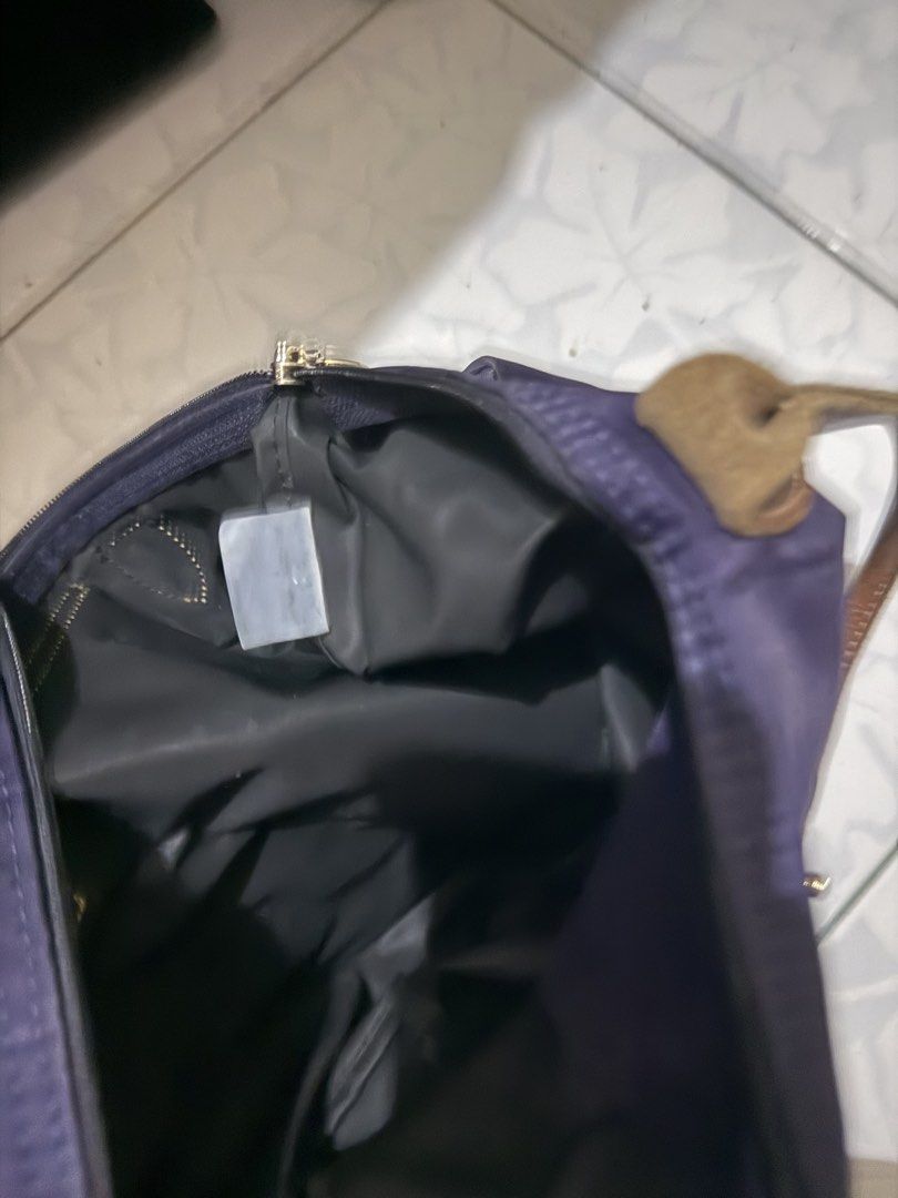 Longchamp Le Pliage Tote Bag (Category: Luxury Bags & Wallets) located in Muntinlupa City. Submitted by closet.cloud (Listing ID 1462020539, Image 3). Description: - Classic Longchamp tote bag - Deep purple color - Genuine leather handles and trim - Folds flat for convenient storage - Ideal for everyday use or travel - Spacious interior - Secure zipper closure.