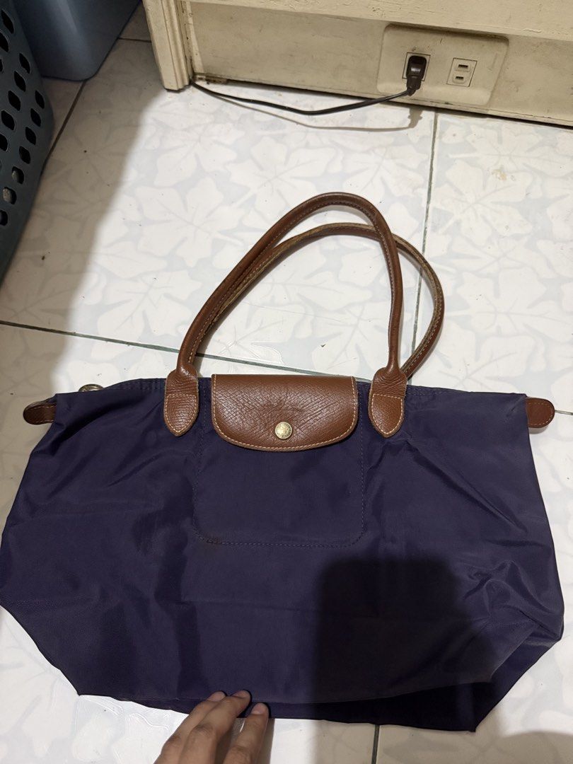Longchamp Le Pliage Tote Bag (Category: Luxury Bags & Wallets) located in Muntinlupa City. Submitted by closet.cloud (Listing ID 1462020539, Image 1). Description: - Classic Longchamp tote bag - Deep purple color - Genuine leather handles and trim - Folds flat for convenient storage - Ideal for everyday use or travel - Spacious interior - Secure zipper closure.