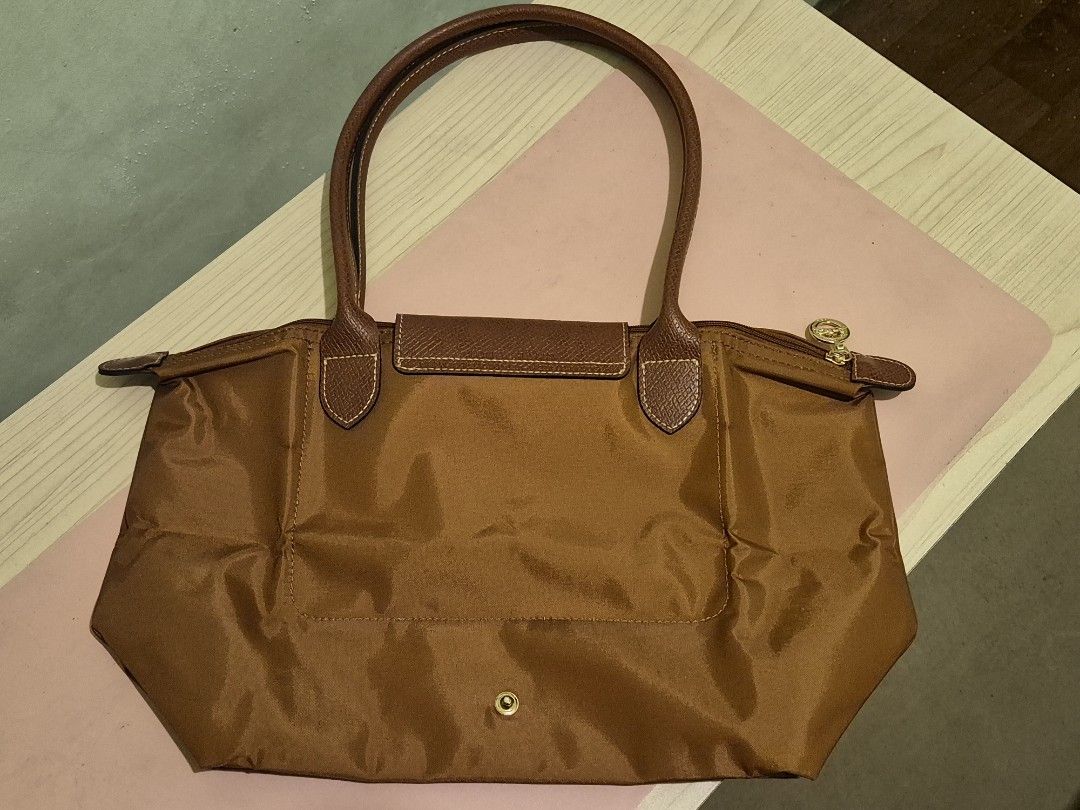 Longchamp Le Pliage Tote Bag - Brown (Category: Tote Bags) located in Quezon City. Submitted by gbabesy2.0 (Listing ID 1461803710, Image 2). Description: Longchamp Le Pliage Medium Long Handle Tote - Rich brown color (Conjac) - Durable nylon with leather accents - Gold-toned hardware - Zipper closure (YKK zipper with number '45') - Longchamp logo zipper pull and snap button - Medium size, perfect for everyday - Folds flat for easy storage - Clear