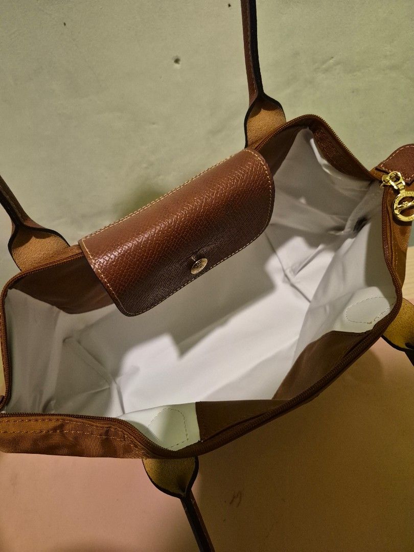 Longchamp Le Pliage Tote Bag - Brown (Category: Tote Bags) located in Quezon City. Submitted by gbabesy2.0 (Listing ID 1461803710, Image 3). Description: Longchamp Le Pliage Medium Long Handle Tote - Rich brown color (Conjac) - Durable nylon with leather accents - Gold-toned hardware - Zipper closure (YKK zipper with number '45') - Longchamp logo zipper pull and snap button - Medium size, perfect for everyday - Folds flat for easy storage - Clear