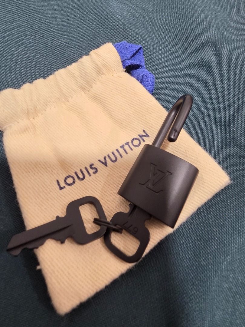 Louis Vuitton Lock and Keys with Dust Bag (Category: Luxury Bags & Wallets) located in Cordon. Submitted by jrluxurs (Listing ID 1462016020, Image 3). Description: - Authentic Louis Vuitton lock and 2 keys - Includes original dust bag - Stylish matte black finish - Ideal for securing your LV bag or as a collectible.