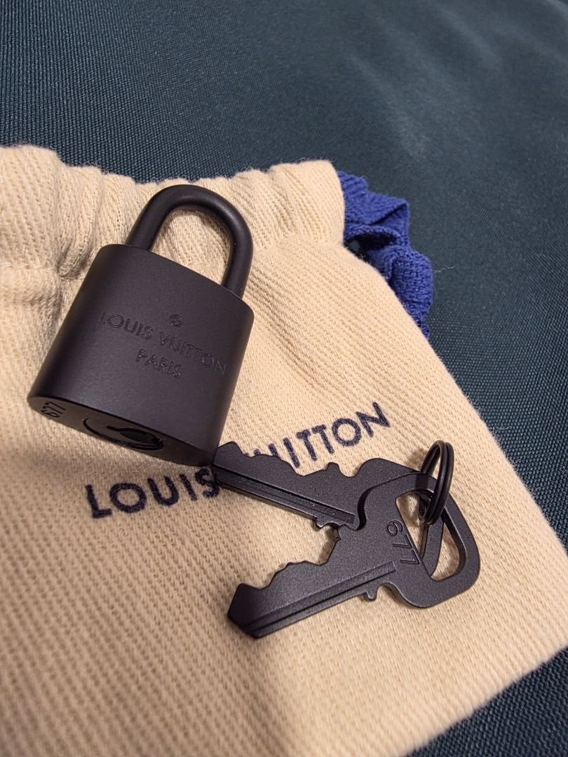 Louis Vuitton Lock and Keys with Dust Bag (Category: Luxury Bags & Wallets) located in Cordon. Submitted by jrluxurs (Listing ID 1462016020, Image 1). Description: - Authentic Louis Vuitton lock and 2 keys - Includes original dust bag - Stylish matte black finish - Ideal for securing your LV bag or as a collectible.