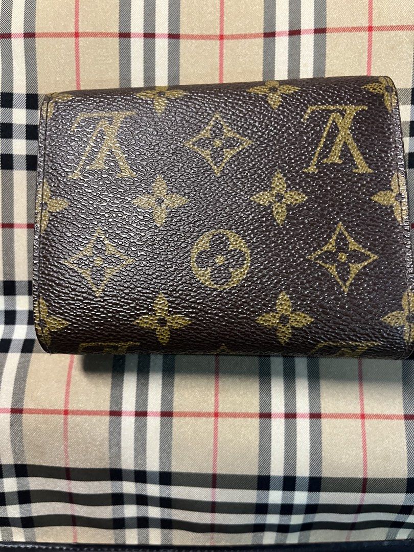 Louis Vuitton Monogram Canvas Bifold Wallet (Category: Luxury Bags & Wallets) located in Cainta. Submitted by eyecandy02 (Listing ID 1461997287, Image 2). Description: - Authentic Louis Vuitton wallet - Classic monogram canvas - Bifold design - Multiple card slots - Zippered coin pocket - Gold-tone hardware - Shows some signs of wear (clasp, edges) consistent with regular use - Functional and stylish piece.