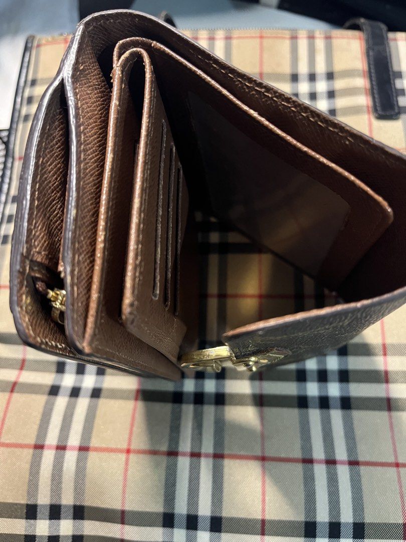 Louis Vuitton Monogram Canvas Bifold Wallet (Category: Luxury Bags & Wallets) located in Cainta. Submitted by eyecandy02 (Listing ID 1461997287, Image 3). Description: - Authentic Louis Vuitton wallet - Classic monogram canvas - Bifold design - Multiple card slots - Zippered coin pocket - Gold-tone hardware - Shows some signs of wear (clasp, edges) consistent with regular use - Functional and stylish piece.