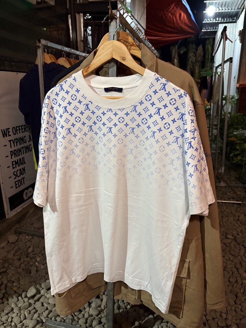 Louis Vuitton Monogram T-Shirt White Blue (Category: Tshirts & Polo Shirts ) located in Digos. Submitted by razzz08 (Listing ID 1461982262, Image 1). Description: - Authentic Louis Vuitton T-Shirt - Color: White with Blue Monogram Print (fading towards bottom) - Size: L - Made in Italy - Care Instructions: Gentle dry clean only, do not rub, iron inside out. - 23.28.