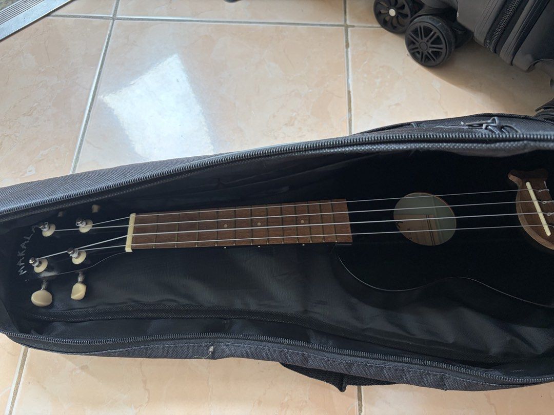 Makala Ukulele (Soprano size) (Category: Musical Instruments) located in Manila. Submitted by aman.sinaya01 (Listing ID 1461810282, Image 2). Description: - Black Makala Ukulele (Model MK-S/BK) - Includes a black gig bag - Ideal for beginners or new players - Features white tuning pegs - Unique wooden bridge design - Ready to play out of the box.