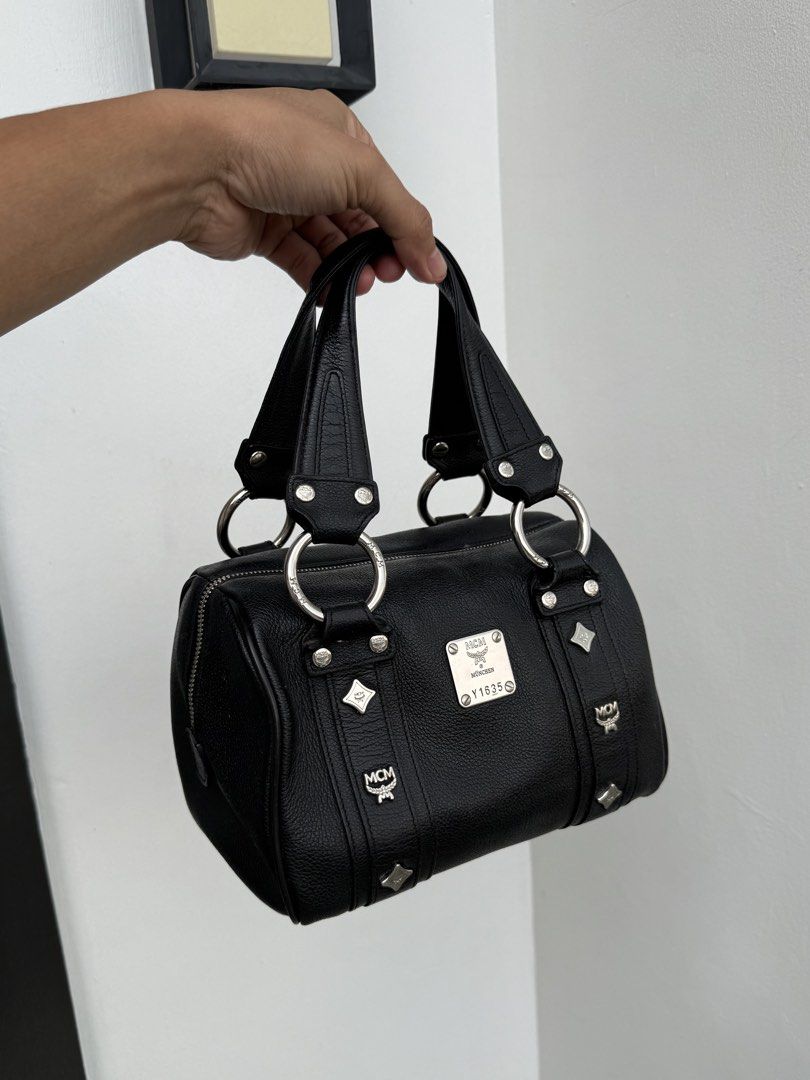 MCM Black leather top handle bag silver hardware (Category: Purses & Pouches) located in Rizal. Submitted by eterna.luxe (Listing ID 1461832368, Image 1). Description: MCM Black leather top handle bag silver hardware Rank A excellent condition Dimensions: Length - 15cm Width - 22cm Depth - 15cm Description * MCM Top Handle Bag * Black Leather * Silver-Tone Hardware * Flat Handles * Studded Accents * Logo Jacquard Lining & Three Interior Pockets *