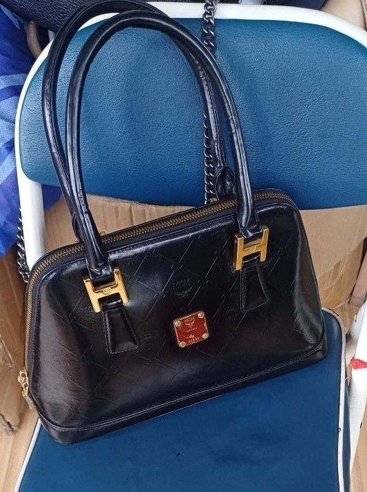 MCM Black Monogrammed Leather Dome Handbag (Category: Luxury Bags & Wallets) located in Manila. Submitted by boldfire_315559 (Listing ID 1461839335, Image 2). Description: - Classic black MCM dome handbag - Signature MCM monogram pattern embossed all over - Gold hardware details - Zipper closure - Interior MCM lining with a small zip pocket - Versatile for everyday or special occasions - A timeless MCM piece.