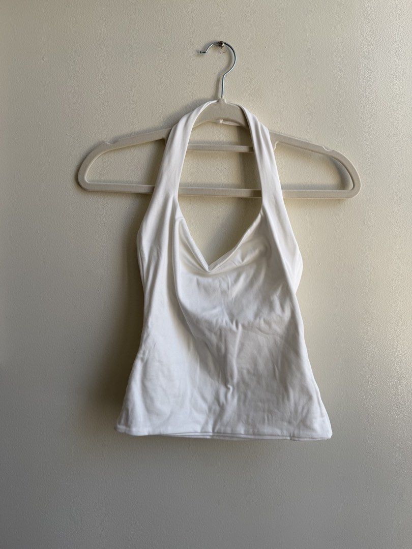 MERA White Halter Neck Top (Category: Sleeveless) located in Makati City. Submitted by andy0019 (Listing ID 1461799403, Image 1). Description: - Brand: MERA - Style: White Halter Neck Top - Design: Simple and chic - Versatility: Great for layering or wearing on its own - Origin: Made in the Philippines - Size: S.