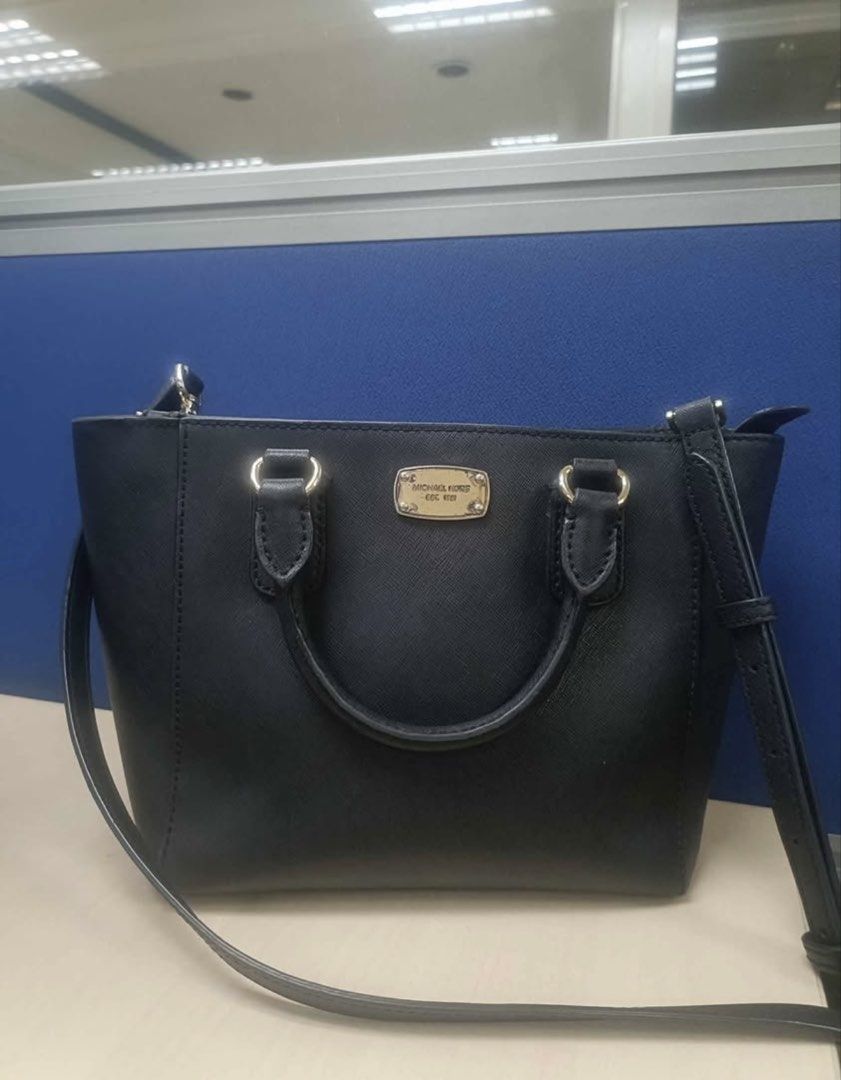 Michael Kors Black Leather Satchel Handbag (Category: Luxury Bags & Wallets) located in Valenzuela. Submitted by boutiquechic (Listing ID 1461942256, Image 1). Description: - Michael Kors black leather satchel - Top handles - Detachable crossbody strap - Gold-tone hardware - Michael Kors logo plate on front - Clean interior - Ideal for everyday use.